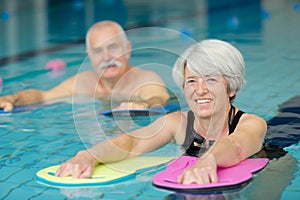 portrait senior man and woman in swimming pool