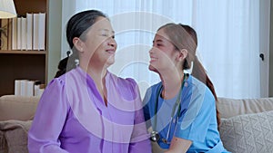 Portrait senior mother and daughter is nurse smile sitting on sofa in living room at home.