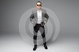 Portrait of senior older business man standing wearing dark sunglasses isolated on white background