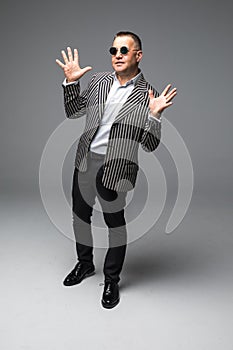 Portrait of senior older business man standing wearing dark sunglasses isolated on white background