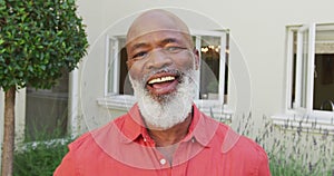 Portrait of senior smiling african american man looking at camera in garden