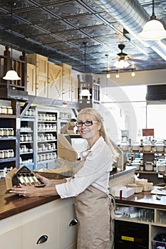 Portrait of a senior spice merchant standing at counter in store