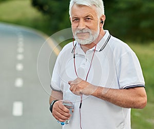 Portrait of senior sportman keeping water bottle.