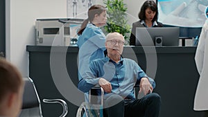 Portrait of senior wheelchair user sitting in waiting room area