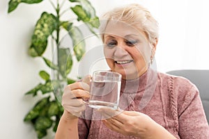 Portrait of a senior woman drinking a glass of water