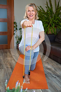 Portrait of senior woman exercise in for sports at home.