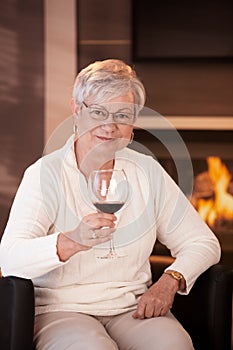 Portrait of senior woman with glass of wine