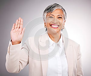 Portrait, senior woman and hand for loyalty, justice or a wave on a studio background. Happy, pledge and a mature