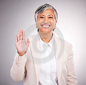 Portrait, senior woman and hand for a wave, justice or a pledge on a studio background. Happy, face and a mature