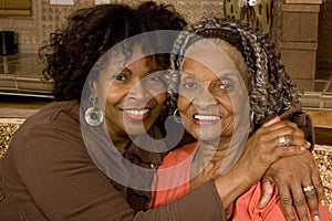 Portrait of a senior woman hugging her daughter.