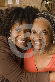 Portrait of a senior woman hugging her daughter.