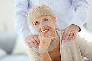 Portrait of senior woman and husband standing behind