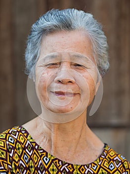 Portrait of a senior woman looking at the camera with a smile while standing outdoors