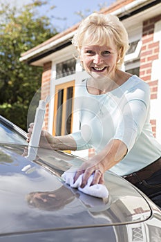 Portrait Of Senior Woman Polishing Car