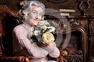 Portrait of senior woman posing with flowers