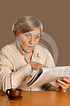 Portrait of a senior woman reading newspaper