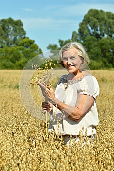 Portrait of senior woman in summer field