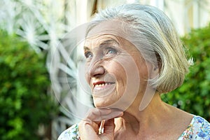 Portrait of senior woman in summer park