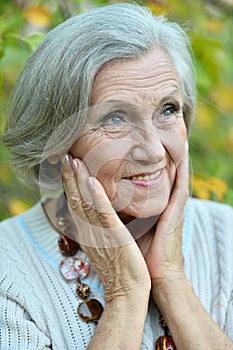 Portrait of senior woman in summer park
