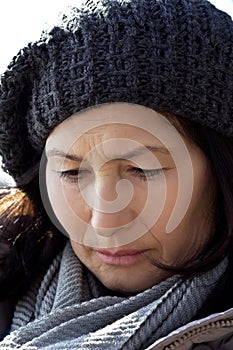 Portrait senior woman in woolen scarf and hat