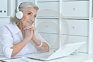 Portrait of senior woman working with laptop