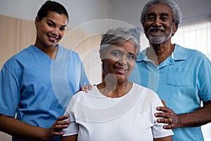 Portrait of seniors with nurse in retirement home