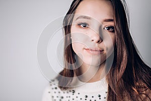 Portrait of sensitive young woman looking at the camera.