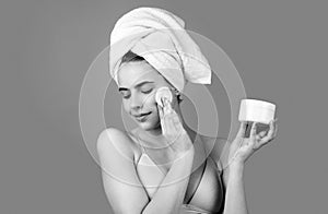 Portrait of sensual beautiful woman. Beauty face of a cheerful attractive girl with towel on head, isolated. Moisturized