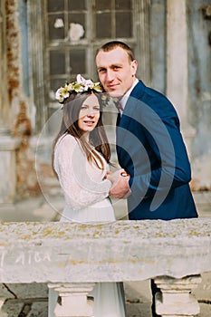 Portrait of sensual just married husband and wife hugging posing in antique ruined palace