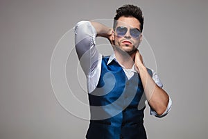 Portrait of sensual man in blue vest posing seductively