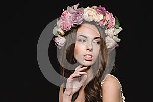 Portrait of sensual seductive young female in flower wreath