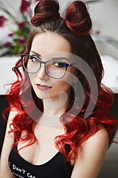Portrait of sensual and hot model girl in bodysuits and fashionable glasses with bright makeup, with red lips and