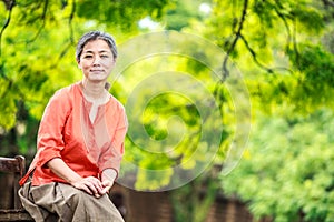 Portrait of serene mature woman in garden