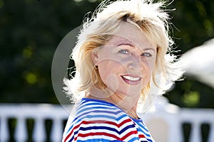 Portrait of serene mature woman in the summer park