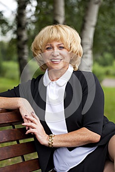 Portrait of serene mature woman in the summer park