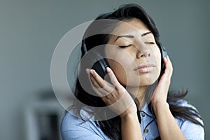 Portrait Of A Serene Spanish Woman Listening Music
