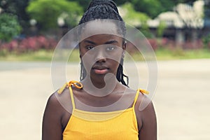 Portrait of serious african american young adult woman with dreadlocks