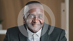 Portrait serious African old senior mature pensive businessman wrinkled male face thoughtful manager in office looking