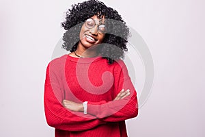 Portrait of a serious african woman with arms folded standing over gray background