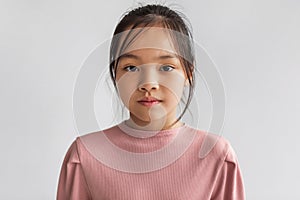 Portrait Of Serious Asian Girl Looking At Camera, Gray Background