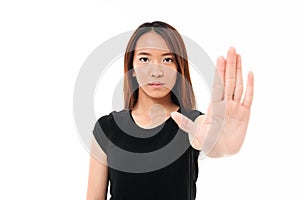 Portrait of serious asian woman standing with outstretched hand