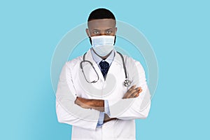 Portrait Of Serious Black Doctor Wearing Protective Face Mask And Uniform