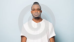 Portrait of serious black man  on blue studio background