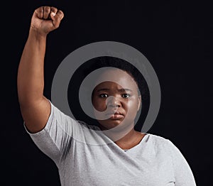 Portrait, serious and black woman on a studio background for a protest, justice or social freedom. Riot, fight and an