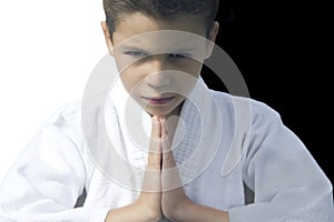 Portrait of a serious boy in a kimono greeting his opponent