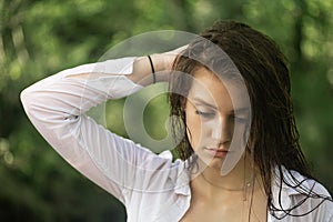 Portrait of serious brunette girl with wet hair