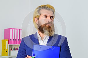 Portrait of serious business man, corporate leader, professional executive, male manager in office holds clipboard with