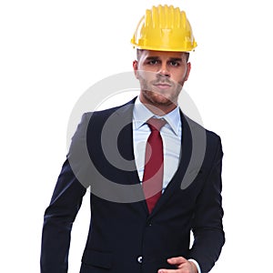 Portrait of serious businessman with construction helmet on head