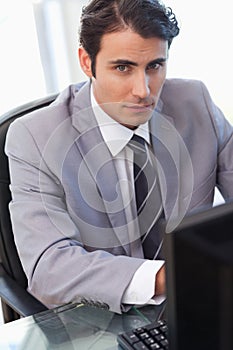 Portrait of a serious businessman working with a computer