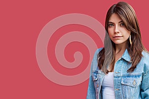 Portrait of serious calm beautiful brunette young woman with makeup in denim casual style standing and looking at camera
